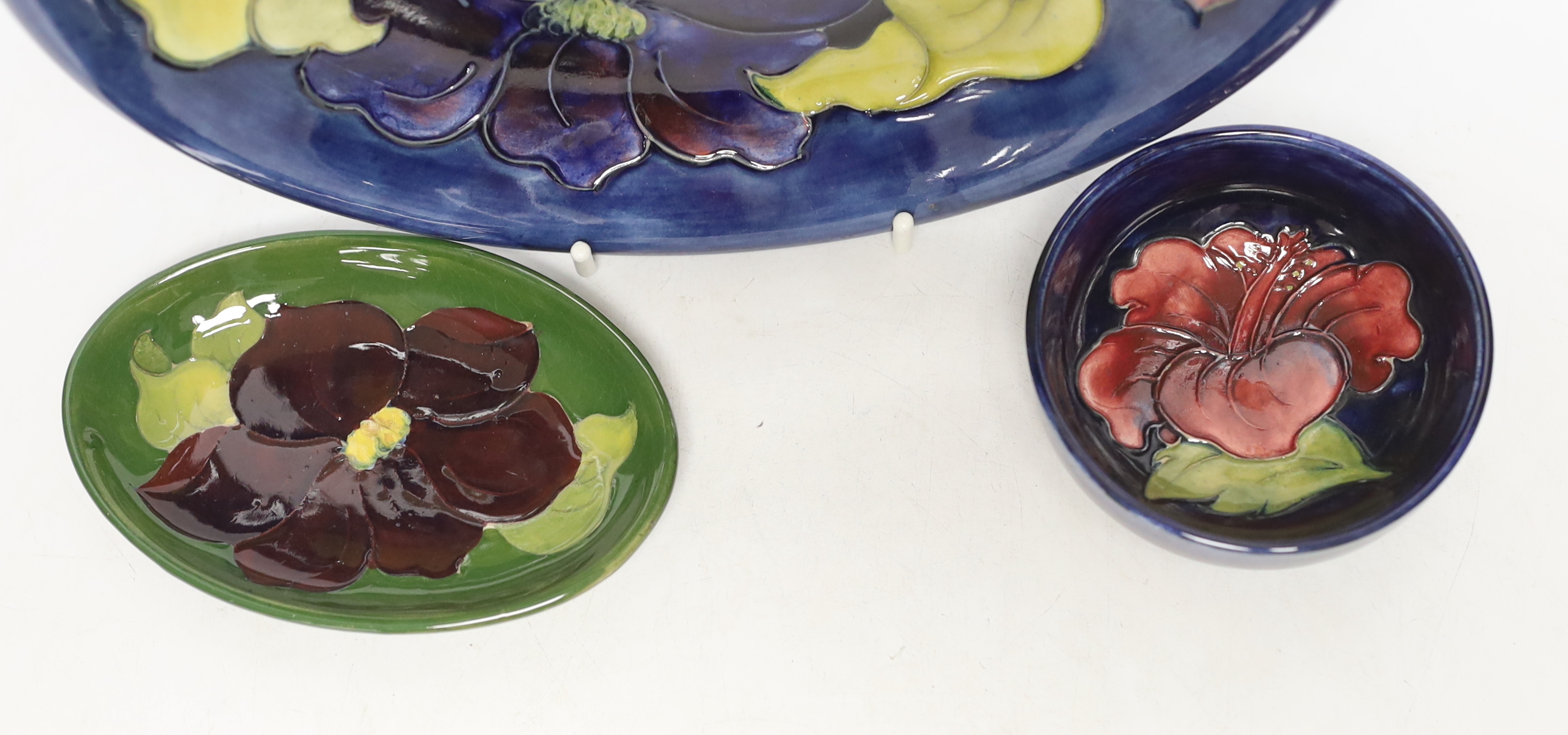 A Moorcroft Pansy plate, pin dish and a small bowl, 22cm in diameter